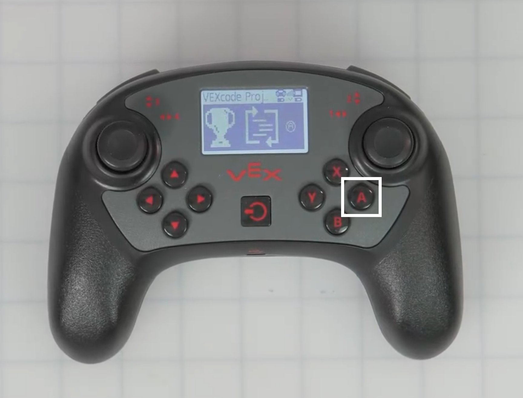 A confirmation page for Programming Skills, showing a trophy, a code icon, and the A button. The A button on the controller is also highlighted.