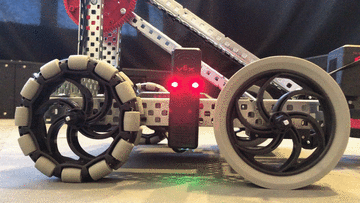 Mounted and wired V5 Robot Radio is shown on a V5 robot. In this example, the Radio's LED lights are flashing red.