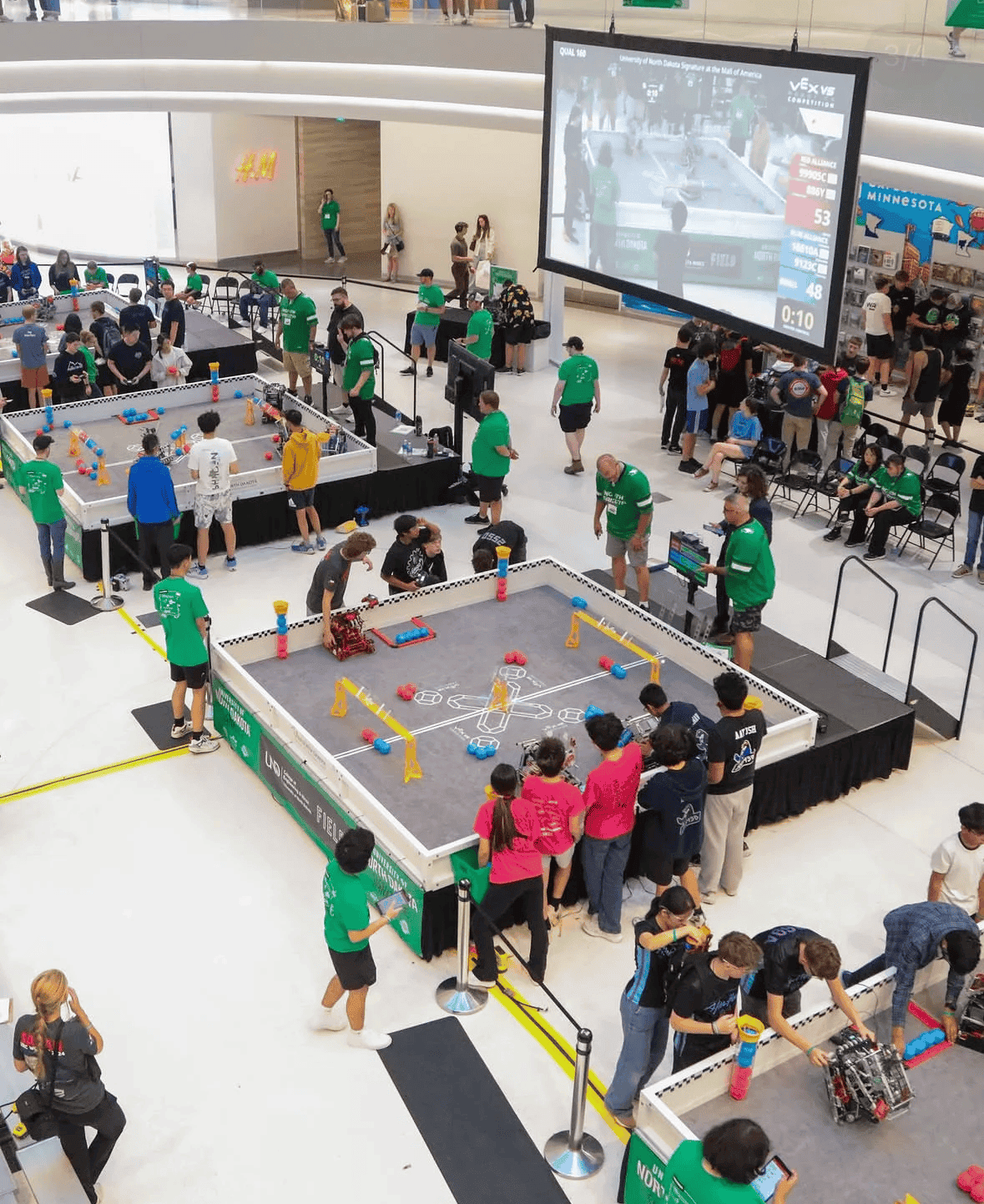 Top down view of four VEX V5 fields with students playing Push Back